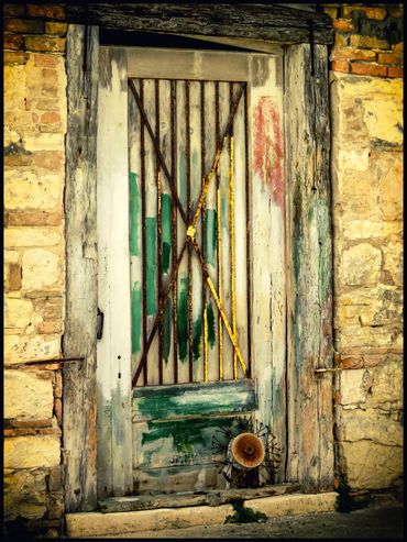 A colorful door with iron bars in ancient building.