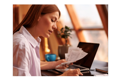 Woman reviewing financial paperwork.