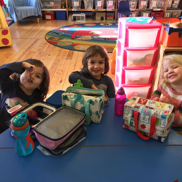 Children eating their packed lunch at playgroup.