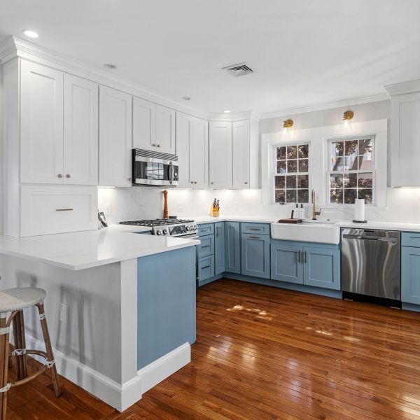 Modern kitchen with blue lower cabinets and white upper cabinets.