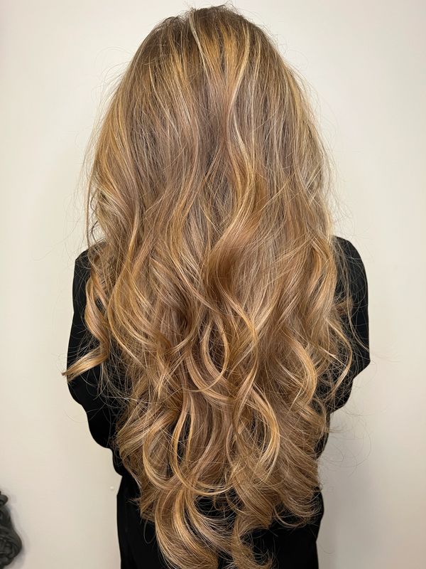 22" IBE hair extensions blown out and set in 2" rollers