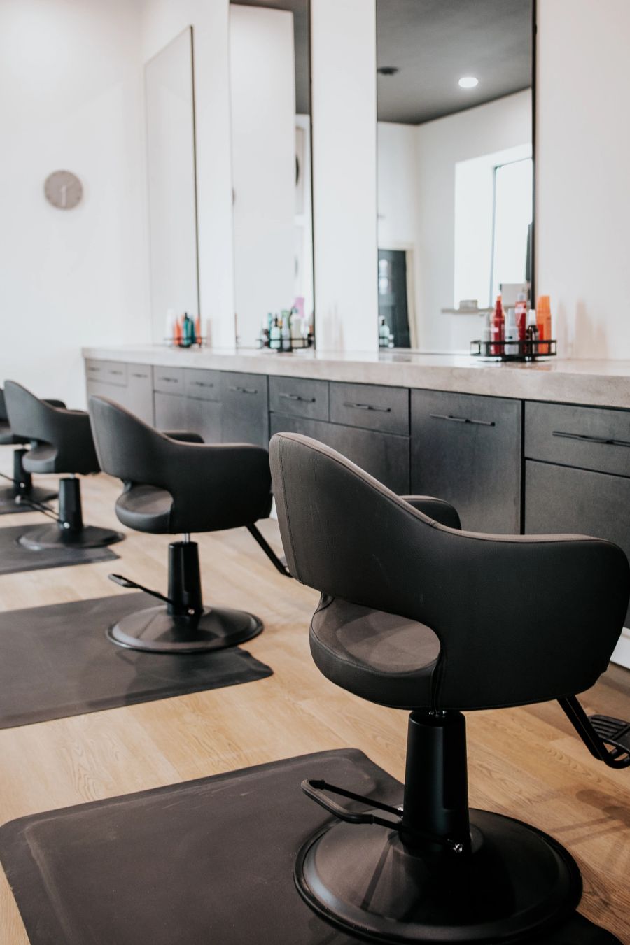 Black styling chairs and mirrored stations