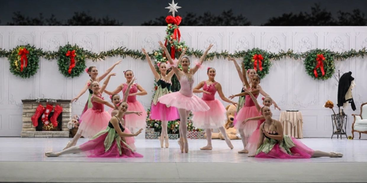 Ballet dancers performing in festive costumes with Christmas decorations.