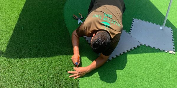 Staff detailing a putting green 