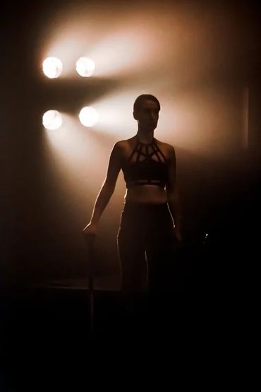 Silhouetted performer against bright stage lights.