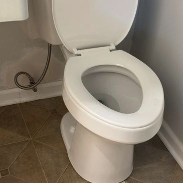 Plumber repairing a leaking toilet or faucet in a Mount Juliet residential bathroom.