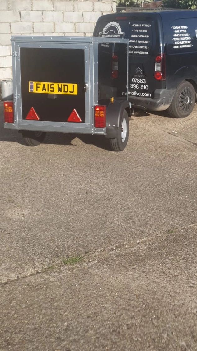 Scenic Monument Valley, Utah with white RV trailer under blue sky