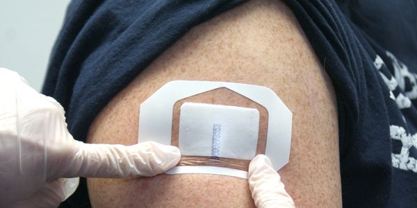 Drug sweatpatch being applied to someone's arm