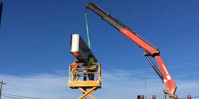 Rusty Nuts Towing & Hiab installing a sign