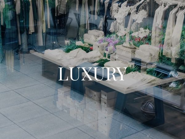 Luxury clothing store contact page with elegant design and floral decor.