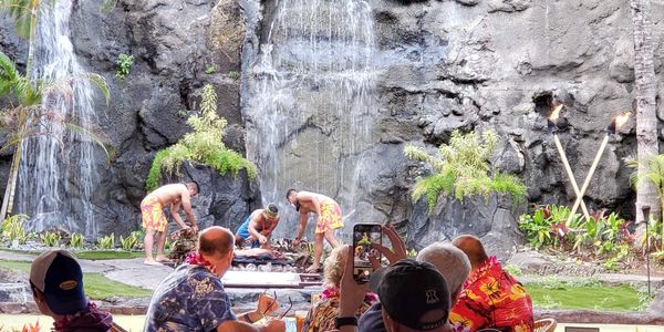 A group of people sitting in front of a mountain