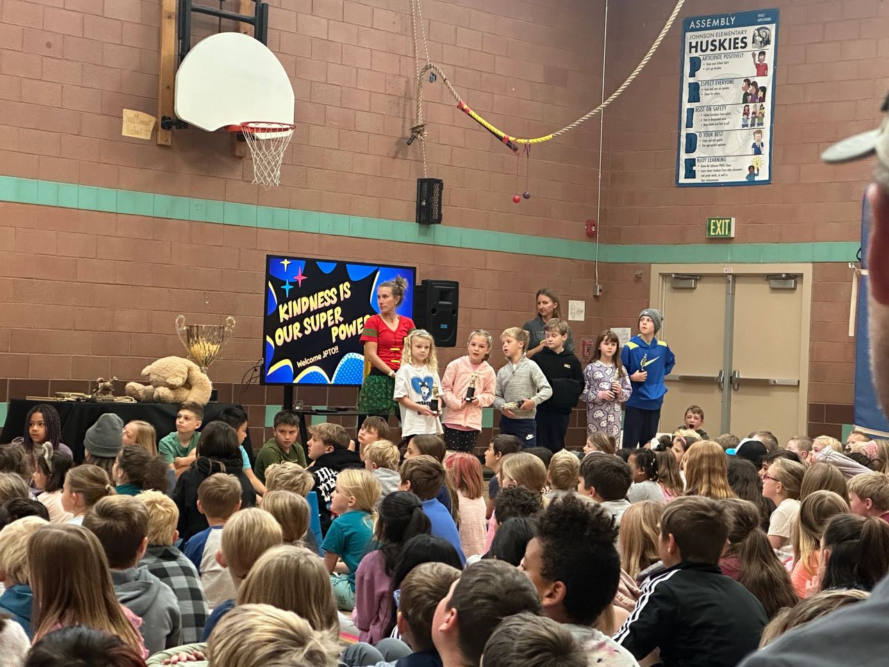 Johnson Students win trophies at PRIDE assembly.