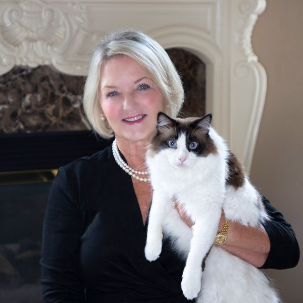 Woman holding a fluffy cat.