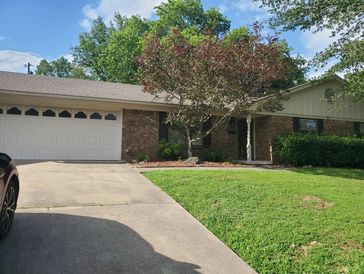 Suburban house with a front lawn and driveway.