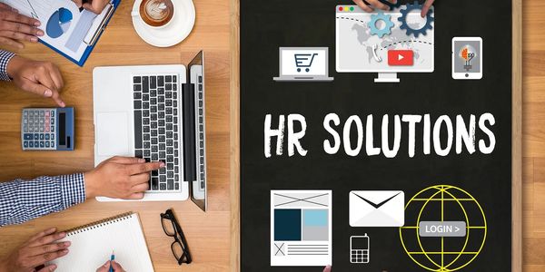 Team collaborating on HR solutions with digital tools and data analysis.