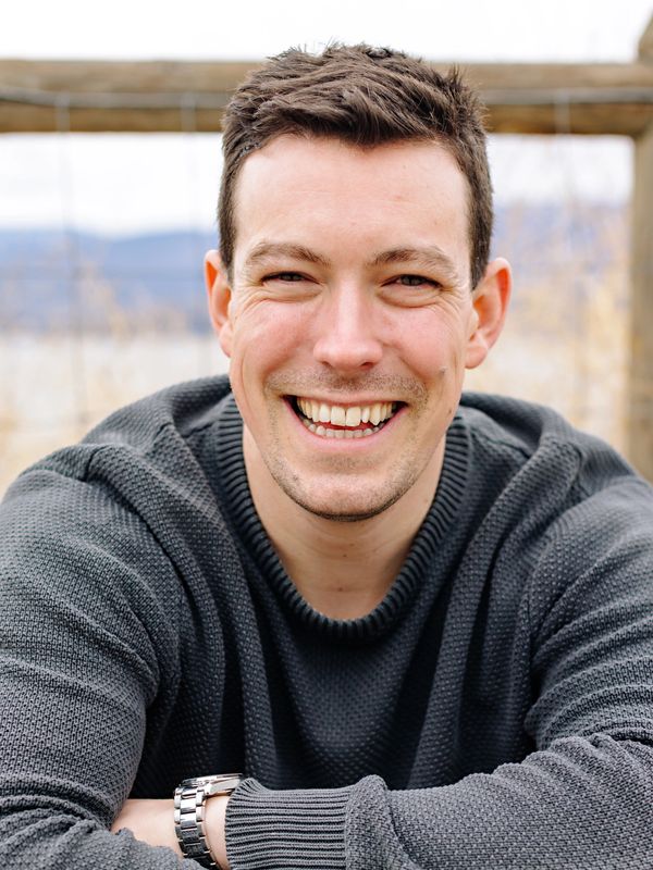 Man sitting down smiling outside