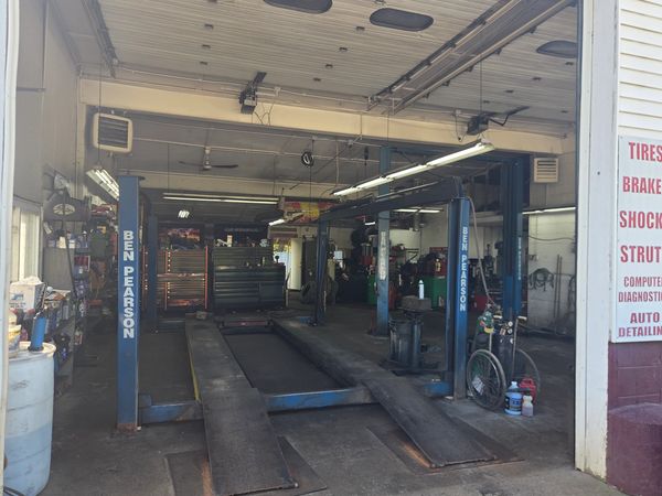 Empty car lift inside an auto repair garage.