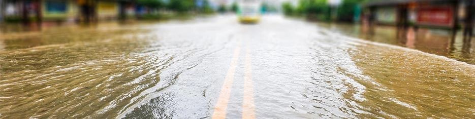 Water covering a road to create a visual picture of a flood.