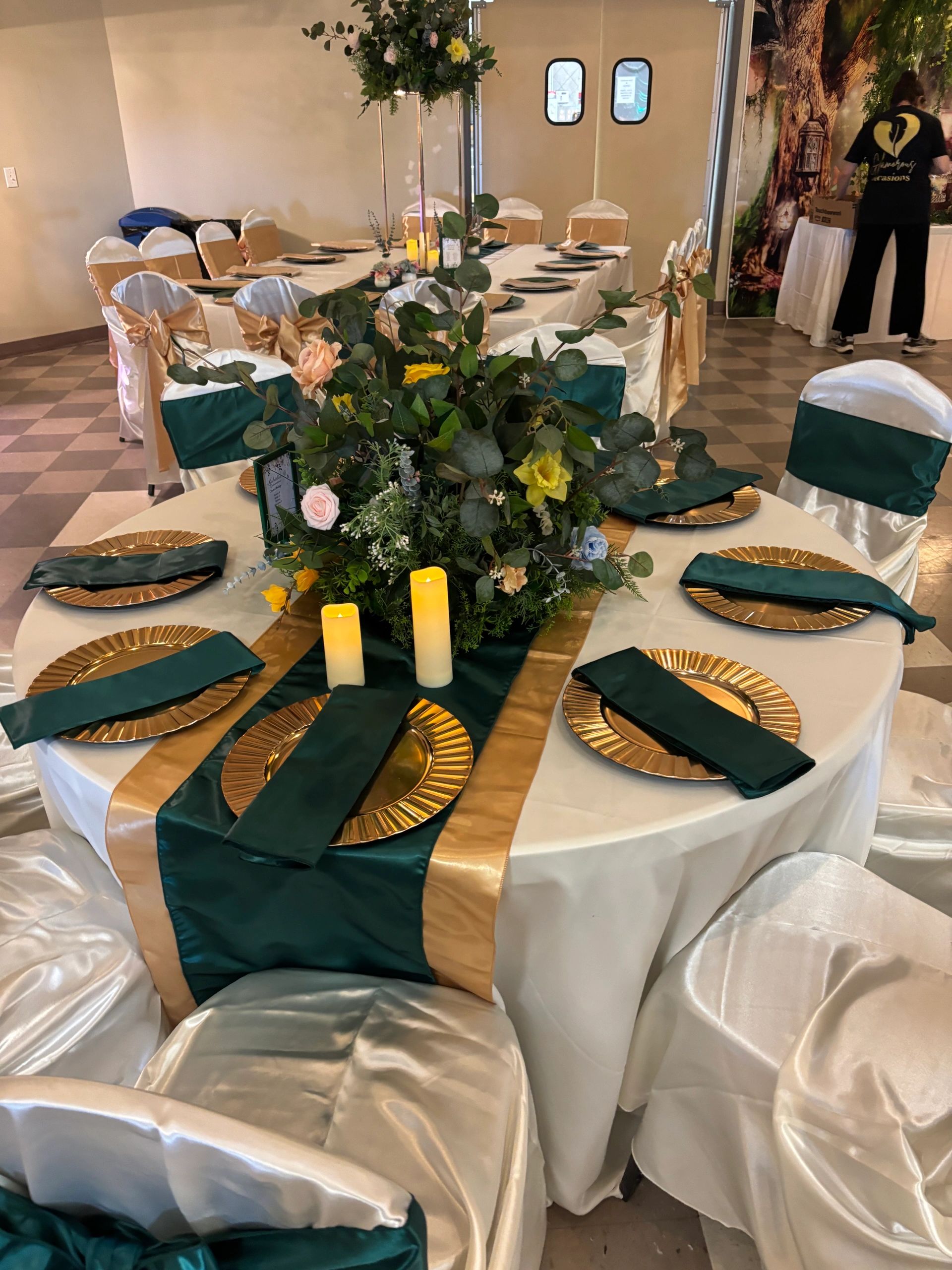 Premium event table styling in Calgary featuring an emerald green and gold tablescape with elegant p