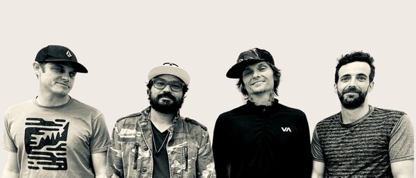 four friends wearing cab and looking ahead