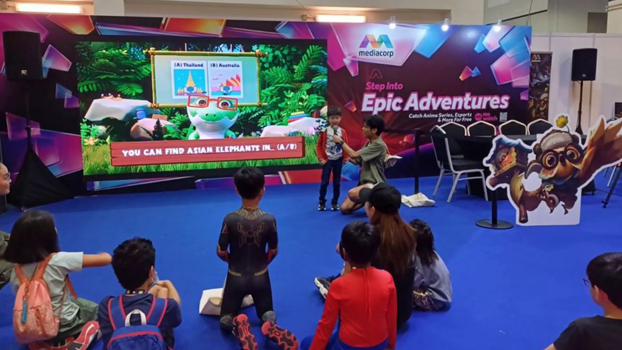 Children engaging in an educational game at an event.