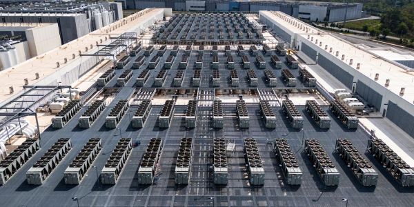 Large array of industrial air conditioning units on a rooftop.