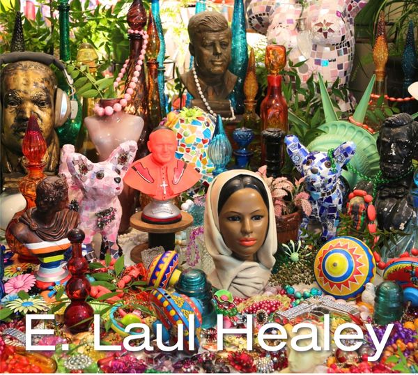 Colorful art display with busts and decorative objects.