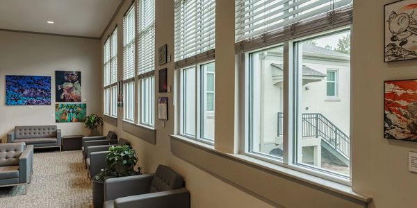 Waiting room in a doctor's office with cordless faux wood blinds. 