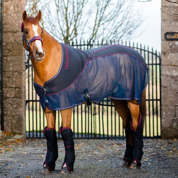 chestnut horse with horseware headstall on and sports cooler rug on anf horseware floating boots on