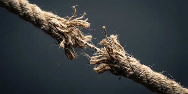 Close-up of a fraying rope about to snap.