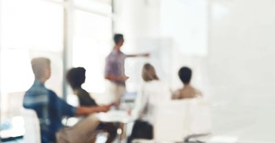 Consultant giving a presentation in a boardroom.