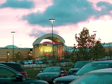 South Park Mall entrance during dusk with parked cars.