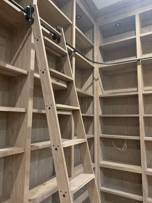 Walnut bookcase with custom library ladder 