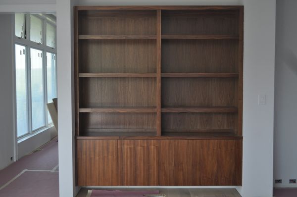 Walnut entertainment cabinet. Modern frameless with slab doors