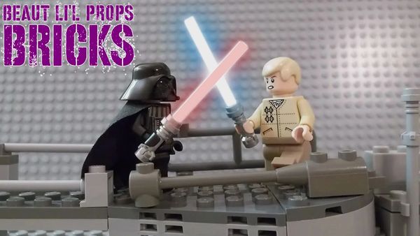 LEGO Darth Vader and Luke Skywalker duel with lightsabers on a gray platform.