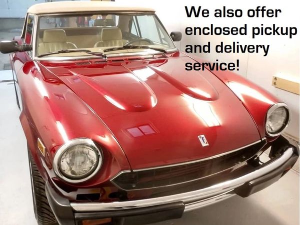 Shiny red classic car with white roof and delivery service offer text.