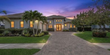 Elegant modern house with a spacious driveway at twilight.