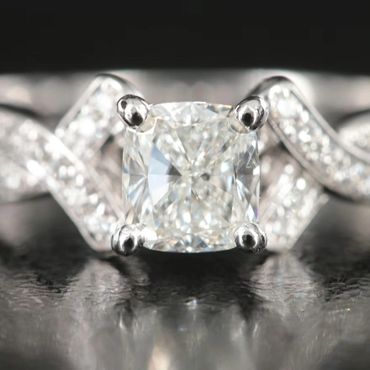 Close-up of a sparkling diamond ring with intricate band design.