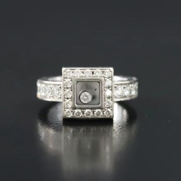 Square diamond ring with central stone and surrounding smaller diamonds.