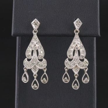 Elegant silver chandelier earrings with intricate detailing.