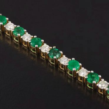 Elegant bracelet with alternating emerald and diamond stones.