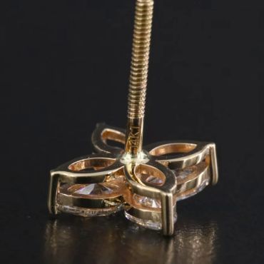 Close-up of a gold and diamond earring stud.