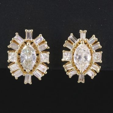 Pair of gold and diamond earrings.