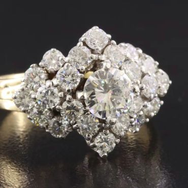 Diamond cluster ring with a large central stone.