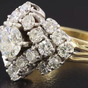 Close-up of a diamond ring with multiple sparkling stones.