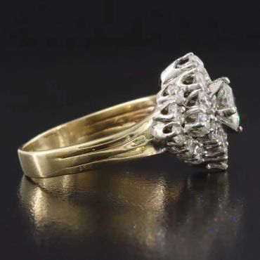 Elegant gold ring with clear gemstones set in intricate metalwork.