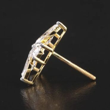 Close-up of a gold and diamond stud earring.