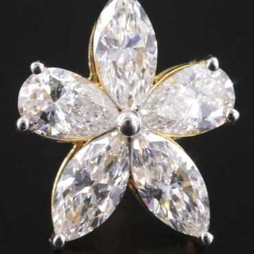 Flower-shaped diamond ring with five large marquise-cut stones.