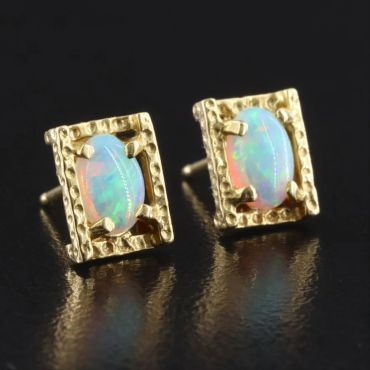 Gold earrings with opal gemstones.