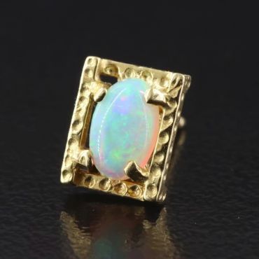 Gold ring with an oval opal stone.